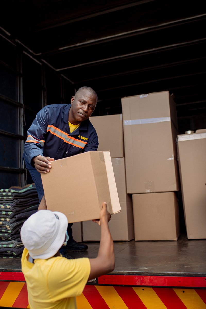 Team loading boxes onto a truck