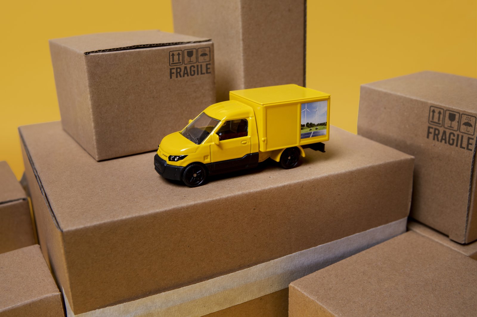 Cardboard boxes and a delivery truck ready for international shipping